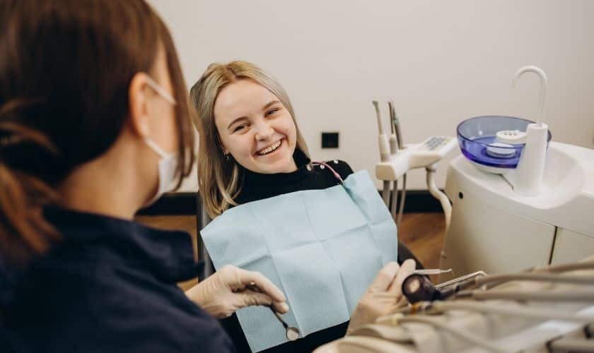 Patient smiling during cosmetic dental consultation in Saginaw dentist office.