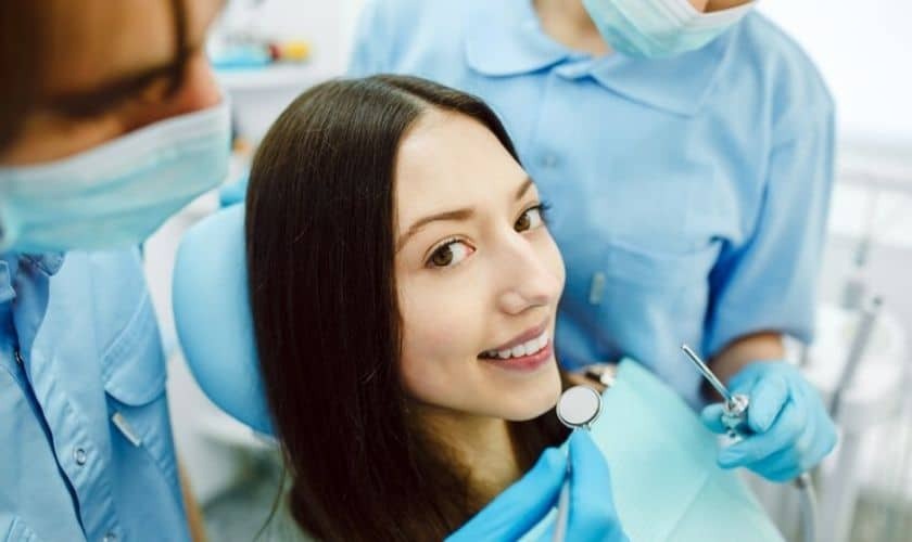 Patient smiling during cosmetic bonding consultation with dentist in Saginaw, MI.