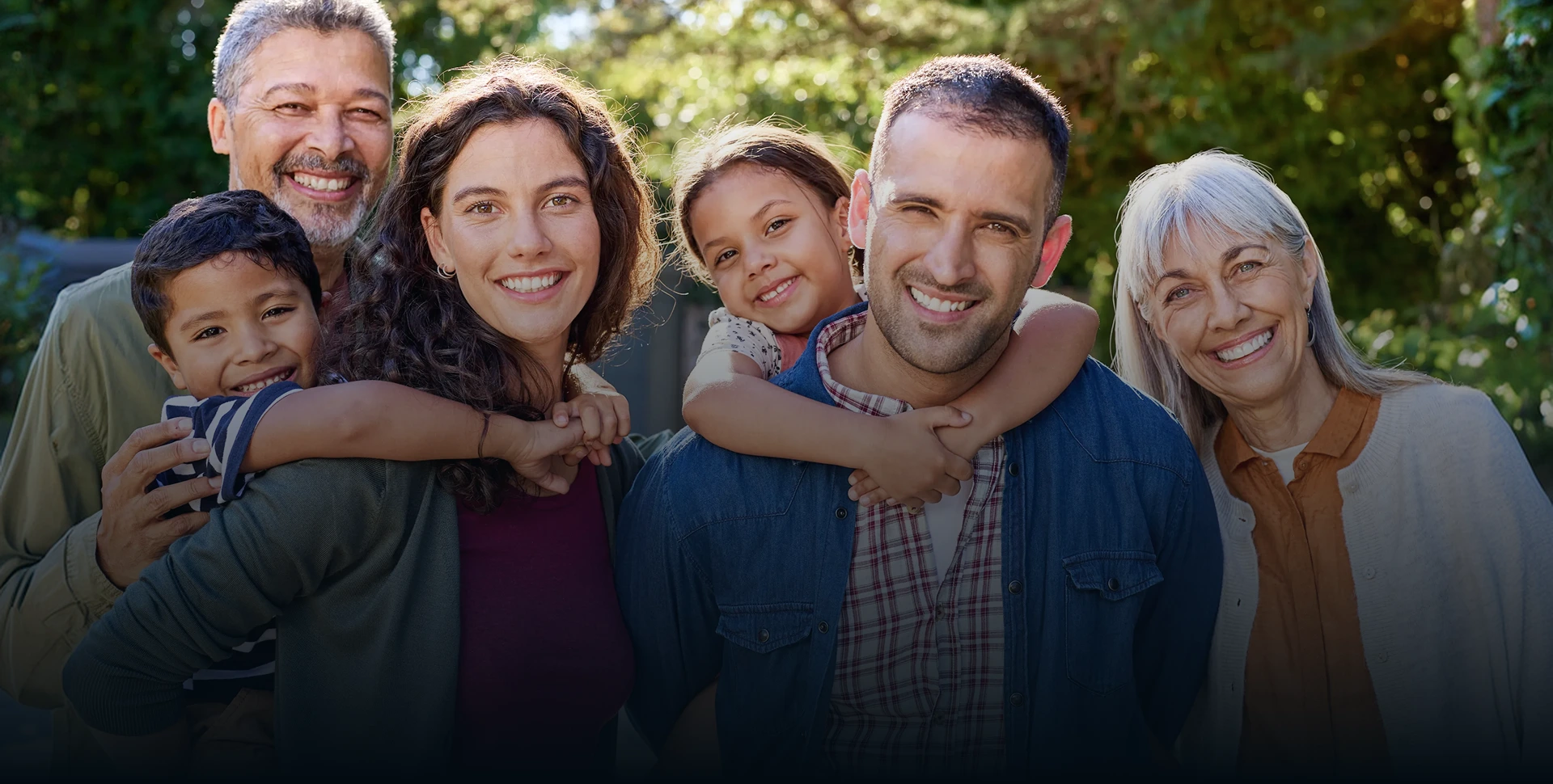 Smiling family standing together outdoors